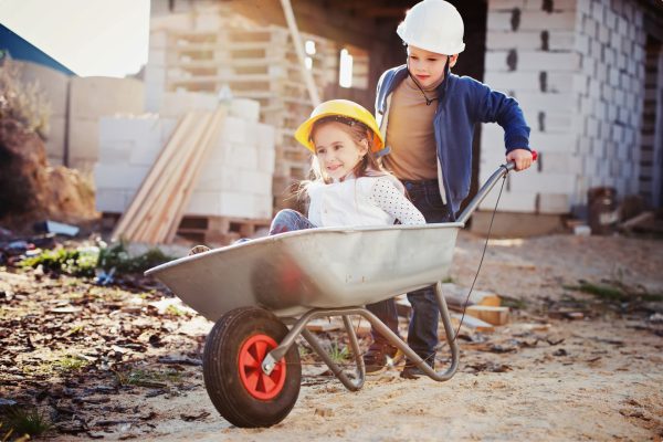 boy and girl playing on construction site